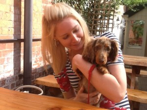 Kate with Ferdie sitting outside at the Swan